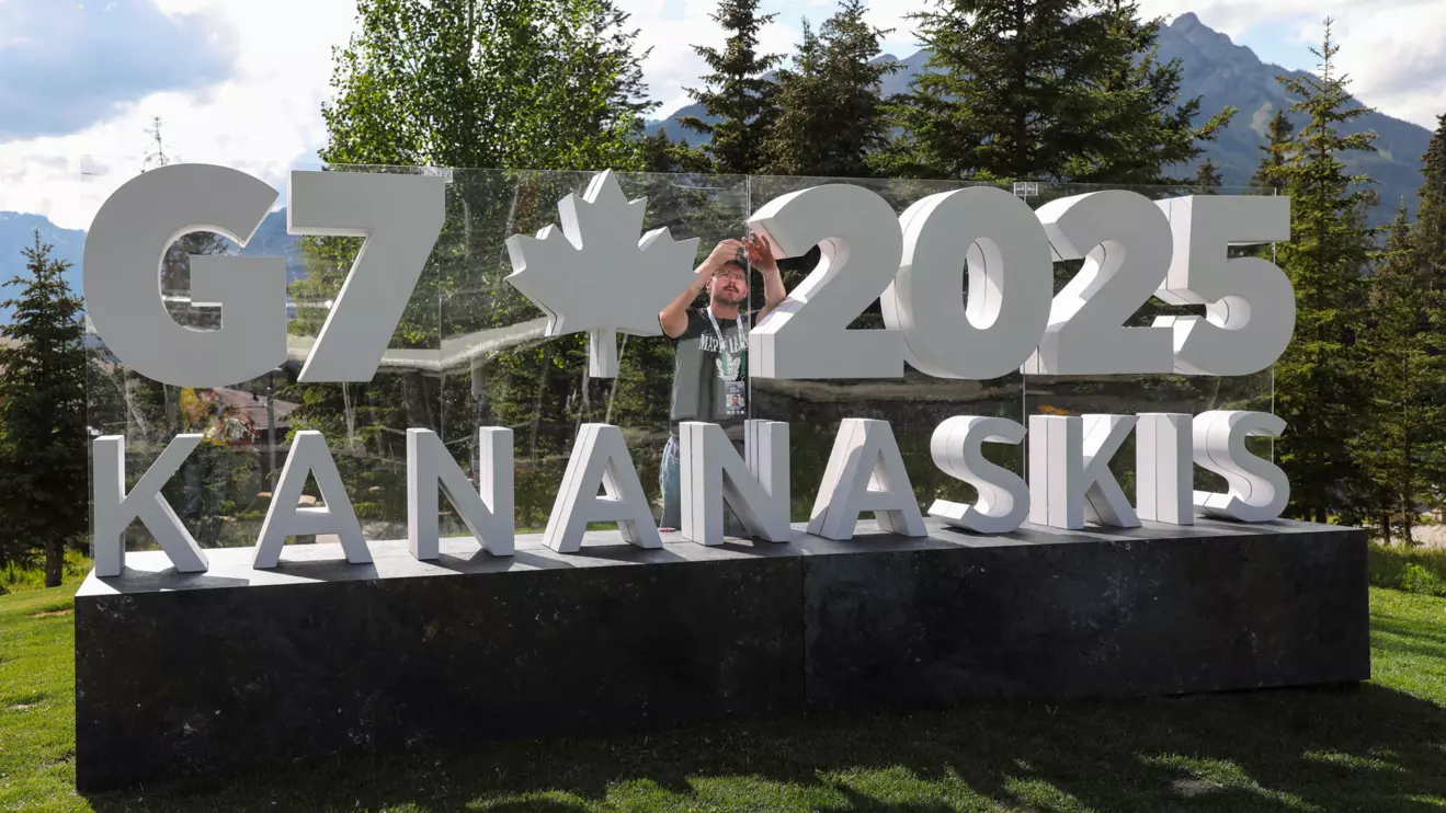 A worker prepares a sign ahead of the G7 summit at a satellite location in Banff, Alberta, Canada, June 14, 2025. Reuters/Amber Bracken
