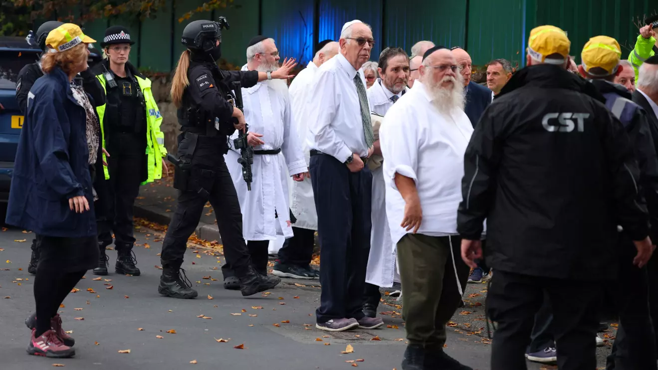 People gather near the scene, after an attack in which a car was driven at pedestrians and stabbings were reported near a synagogue in north Manchester, Britain, October 2, 2025. Reuters/Phil Noble