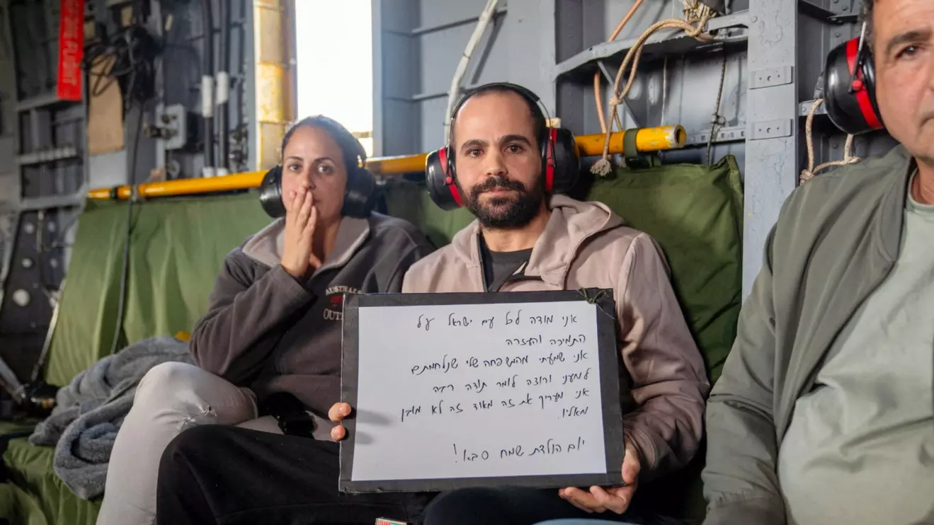 Released Israeli hostage, Yarden Bibas, who was seized during the deadly October 7, 2023 attack by Hamas, holds a whiteboard with the message "I thank all the people of Israel for the support and help. I heard from my family that you fought for me and want to say thank you very much. I appreciate it so much and it's not a given. Happy birthday Grandad!" as he travels to a hospital in a helicopter © Israel Defense Forces