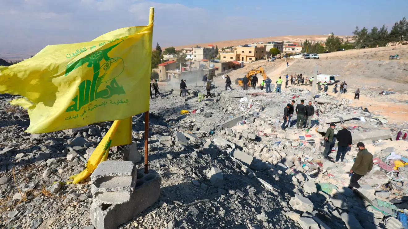 A Hezbollah flag flutters at a site damaged in the aftermath of an Israeli strike on the town of Al-Ain in the Baalbek region, in Lebanon, November 6, 2024. Reuters/Mohammed Yassin