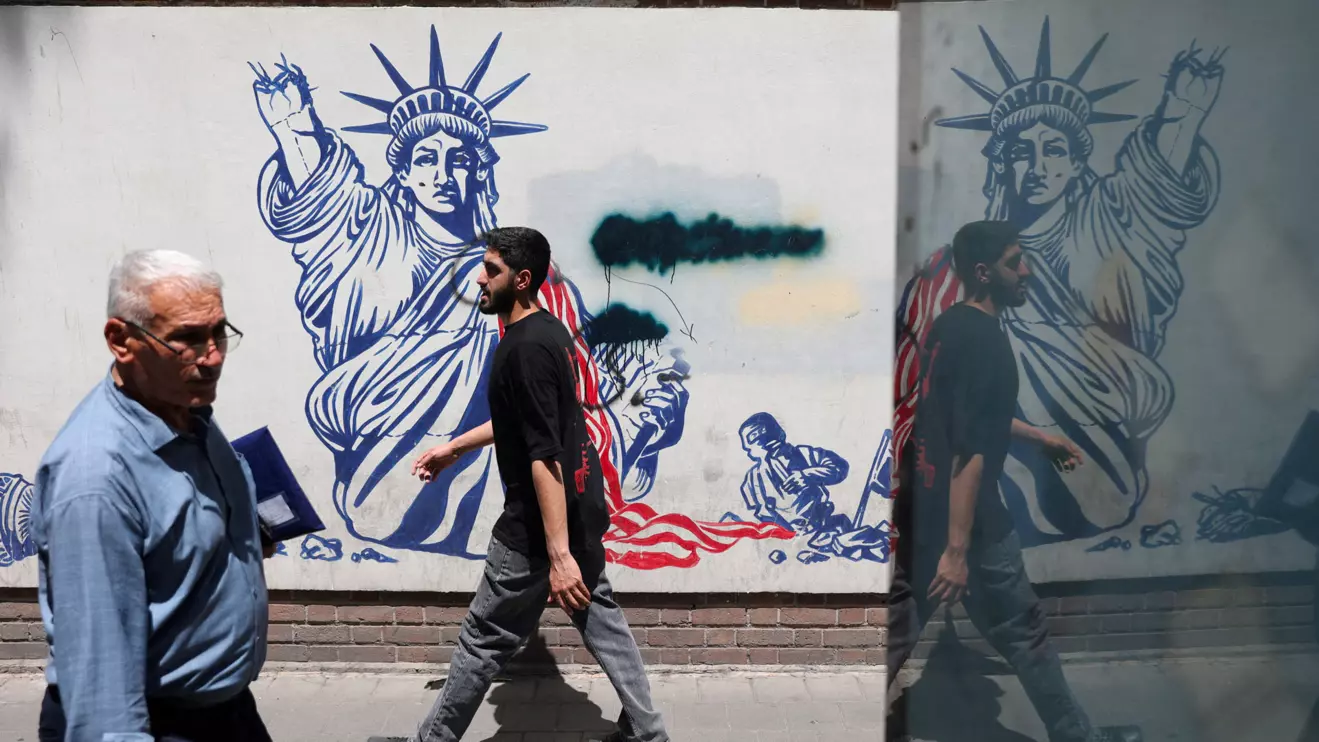 People walk past an anti-U.S. mural on a street in Tehran, Iran, May 11, 2025. Majid Asgaripour/WANA (West Asia News Agency) via Reuters