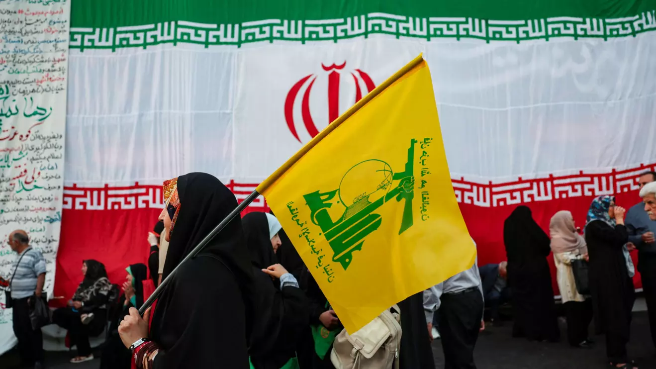 A woman holds a Hezbollah flag during a rally in support of Iran's Supreme Leader, Mojtaba Khamenei, in Tehran, Iran, June 4, 2026. Majid Asgaripour/WANA (West Asia News Agency) via Reuters