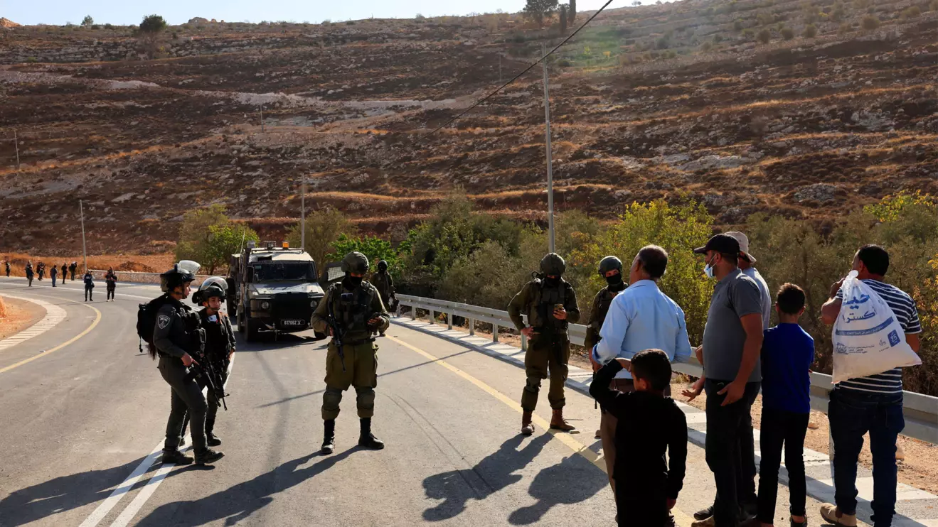 Members of the Israeli forces stand guard as they block the access of Palestinians and foreign activists to olive trees during the olive harvest, near Hebron, in the Israeli-occupied West Bank, October 23, 2025. Reuters/Mussa Qawasma