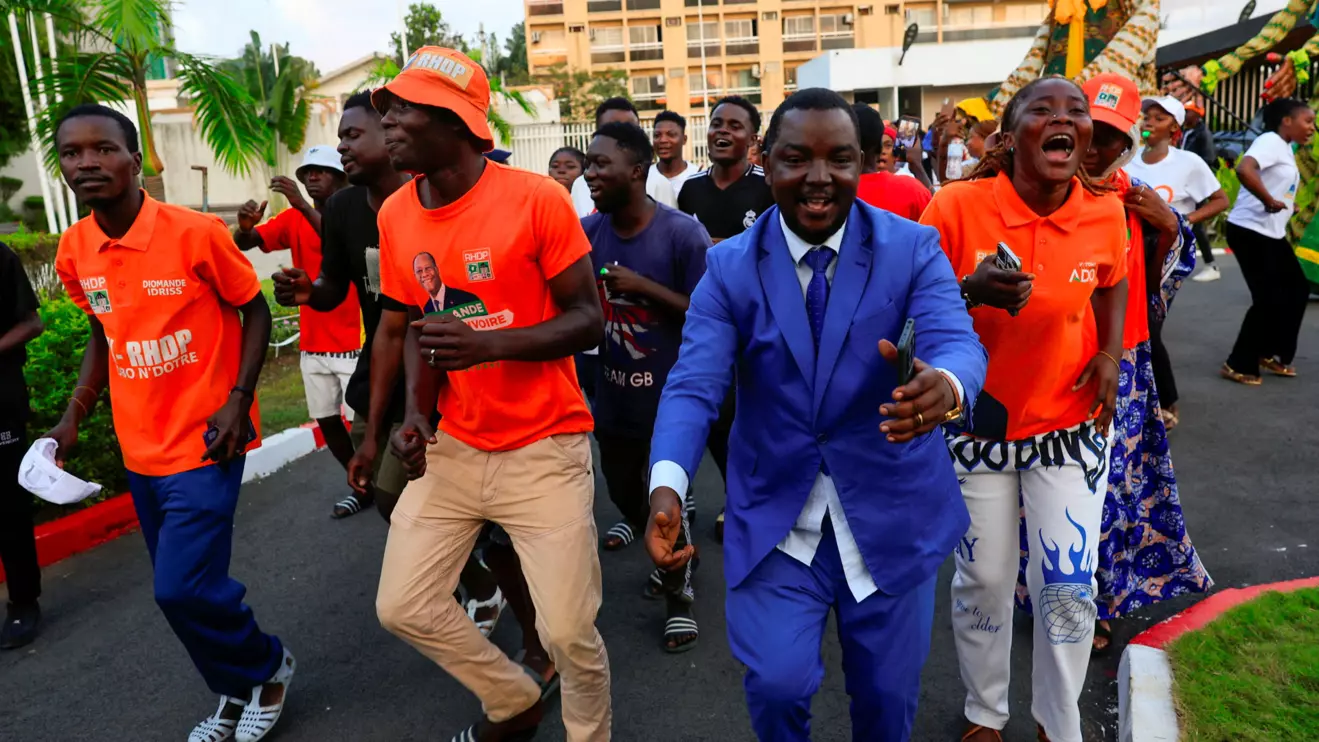 Supporters of Ivory Coast's President Alassane Ouattara, who is seeking a fourth term, celebrate after provisional results were announced by the electoral commission indicating his victory in the presidential election, in Abidjan, Ivory Coast October 27, 2025. Reuters/Luc Gnago