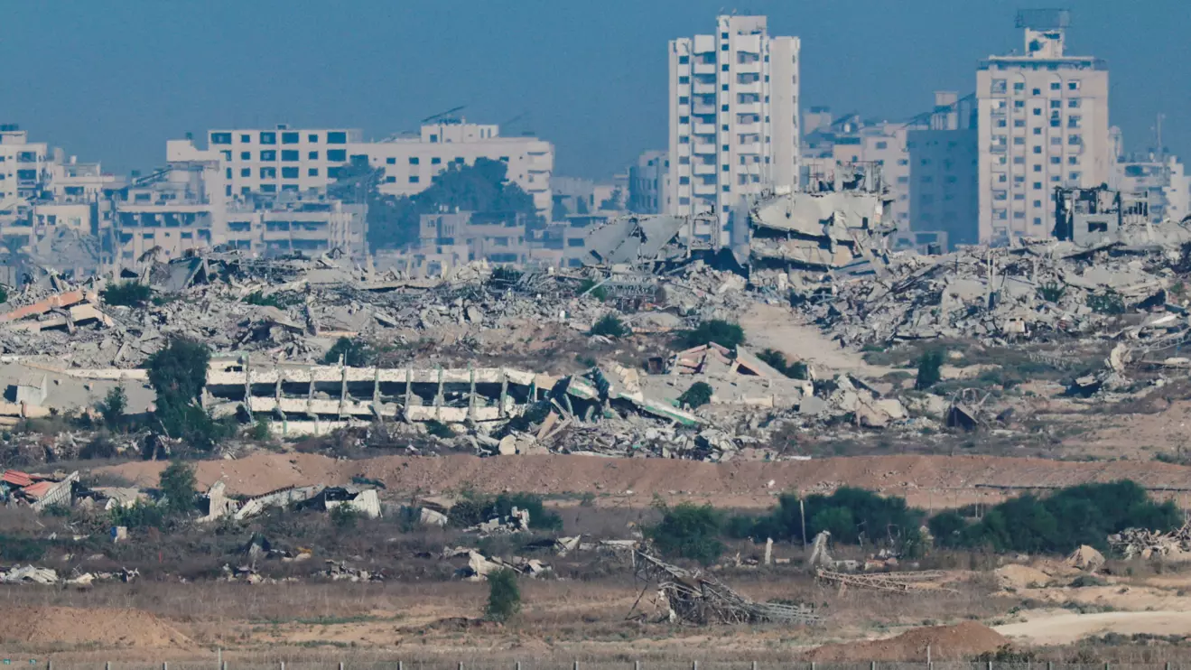 An Armored Personnel Carrier manoeuvres along the Israeli side of the border, as destruction in Gaza is seen in the background, in Israel September 16, 2025. Reuters/Amir Cohen