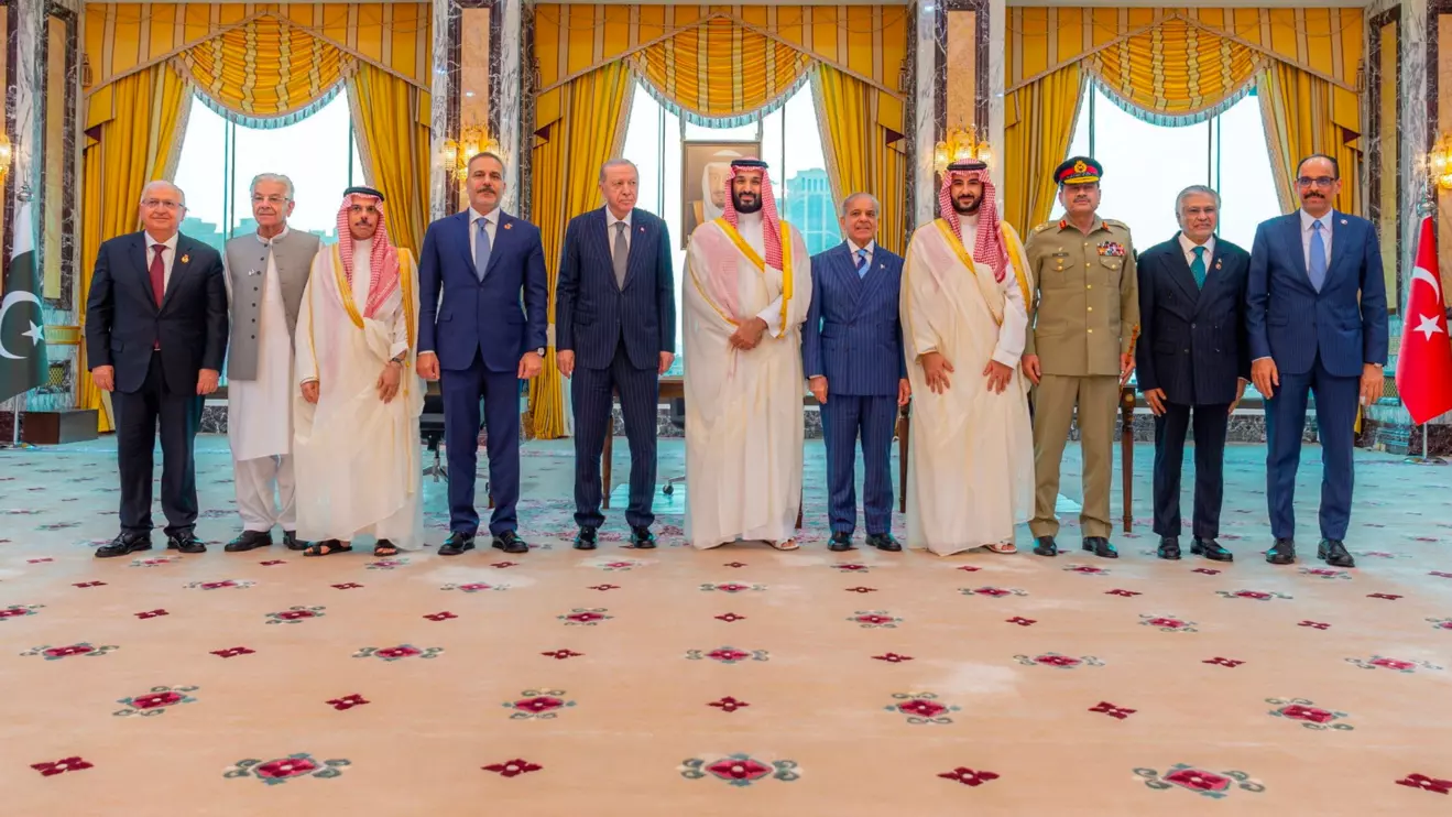 Turkish President Tayyip Erdogan, Saudi Crown Prince Mohammed bin Salman, and Pakistan's Prime Minister Shehbaz Sharif, accompanied by their ministers of Foreign Affairs and Defence, pose after signing a joint defence agreement in Mecca, Saudi Arabia, August 7, 2026. Saudi Press Agency