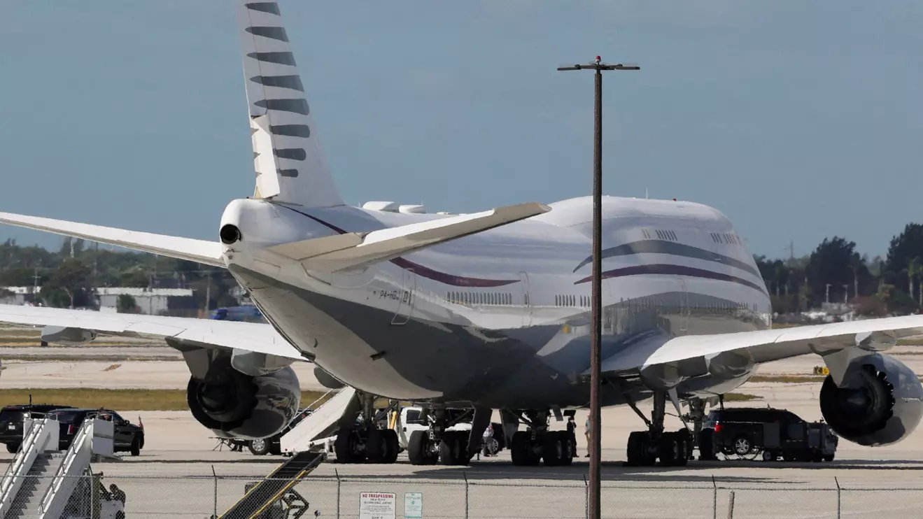 The motorcade of U.S. President Donald Trump is parked next to a 12-year-old Qatari-owned Boeing 747-8 that Trump was touring in West Palm Beach, Florida, U.S., February 15, 2025. Reuters/Kevin Lamarque