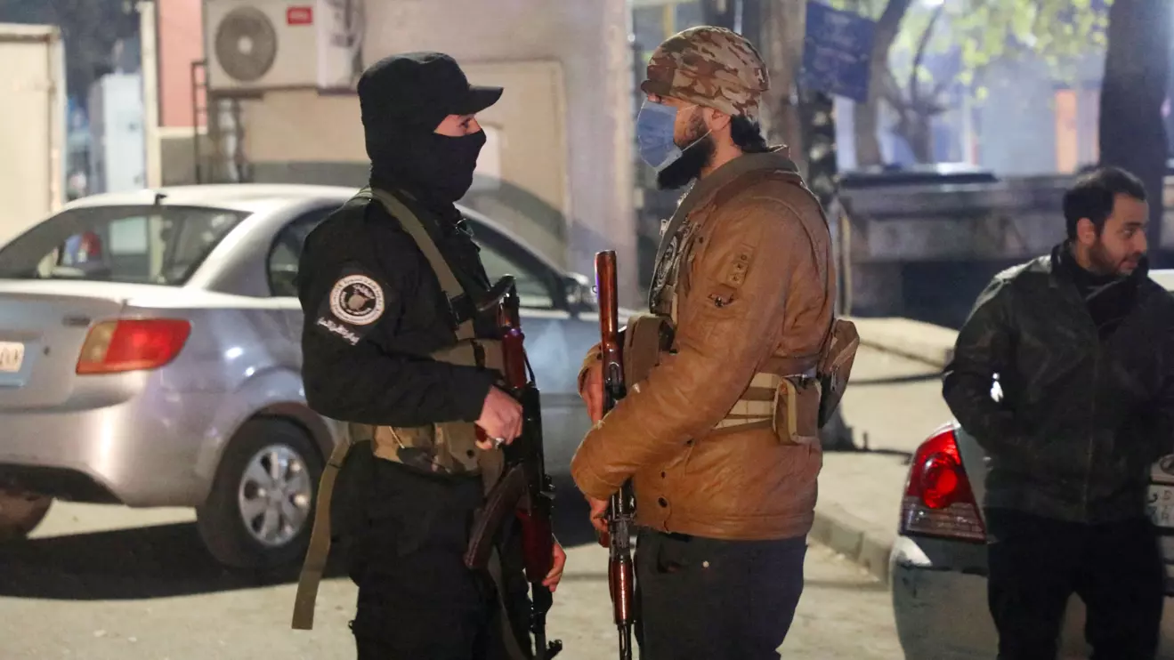 Members of the former rebel group Hayat Tahrir al-Sham stand guard on a street to monitor security and prevent crime in their districts after the ouster of Syria's Bashar al-Assad, in Damascus, Syria, December 31, 2024. Reuters/Khalil Ashawi