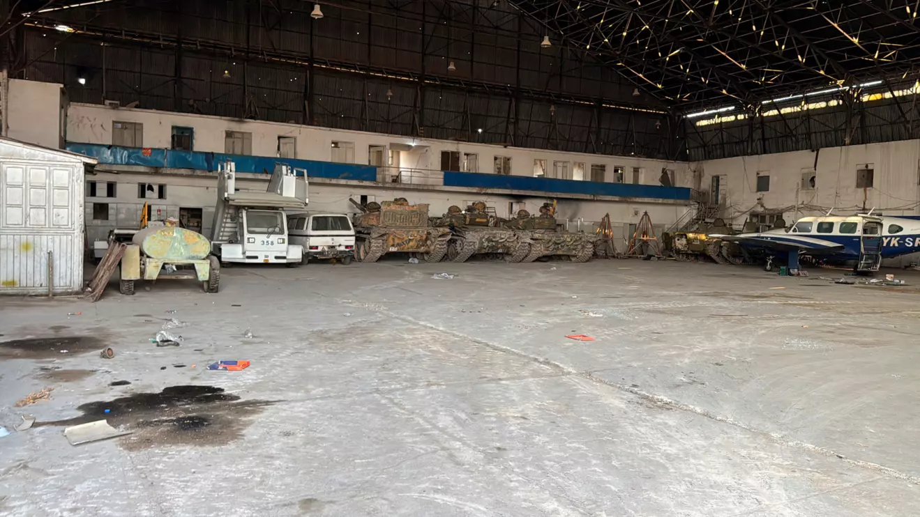 Abandoned tanks, an aircraft and other vehicles are parked in an aircraft hangar at a military airport in the suburb of Mezzeh where many Syrians died in detention, killed by execution, torture or maltreatment at the site that was widely feared, according to a report shared exclusively with Reuters by the Syria Justice and Accountability Centre tracing the deaths to seven suspected grave sites, on the outskirts of Damascus, Syria, December 20, 2024. Reuters/Maggie Michael