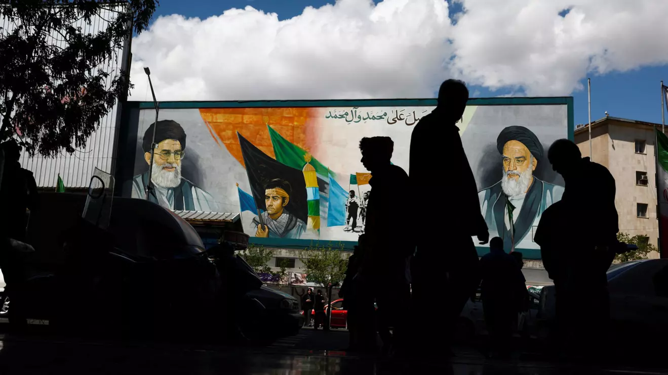 People walk next to a mural depicting the late leader of the Islamic Revolution Ayatollah Ruhollah Khomeini and the late Supreme Leader of Iran Ayatollah Ali Khamenei, after U.S. President Donald Trump said that he had agreed to a two-week ceasefire with Iran, in Tehran, Iran, April 8, 2026. Majid Asgaripour/WANA (West Asia News Agency) via Reuters