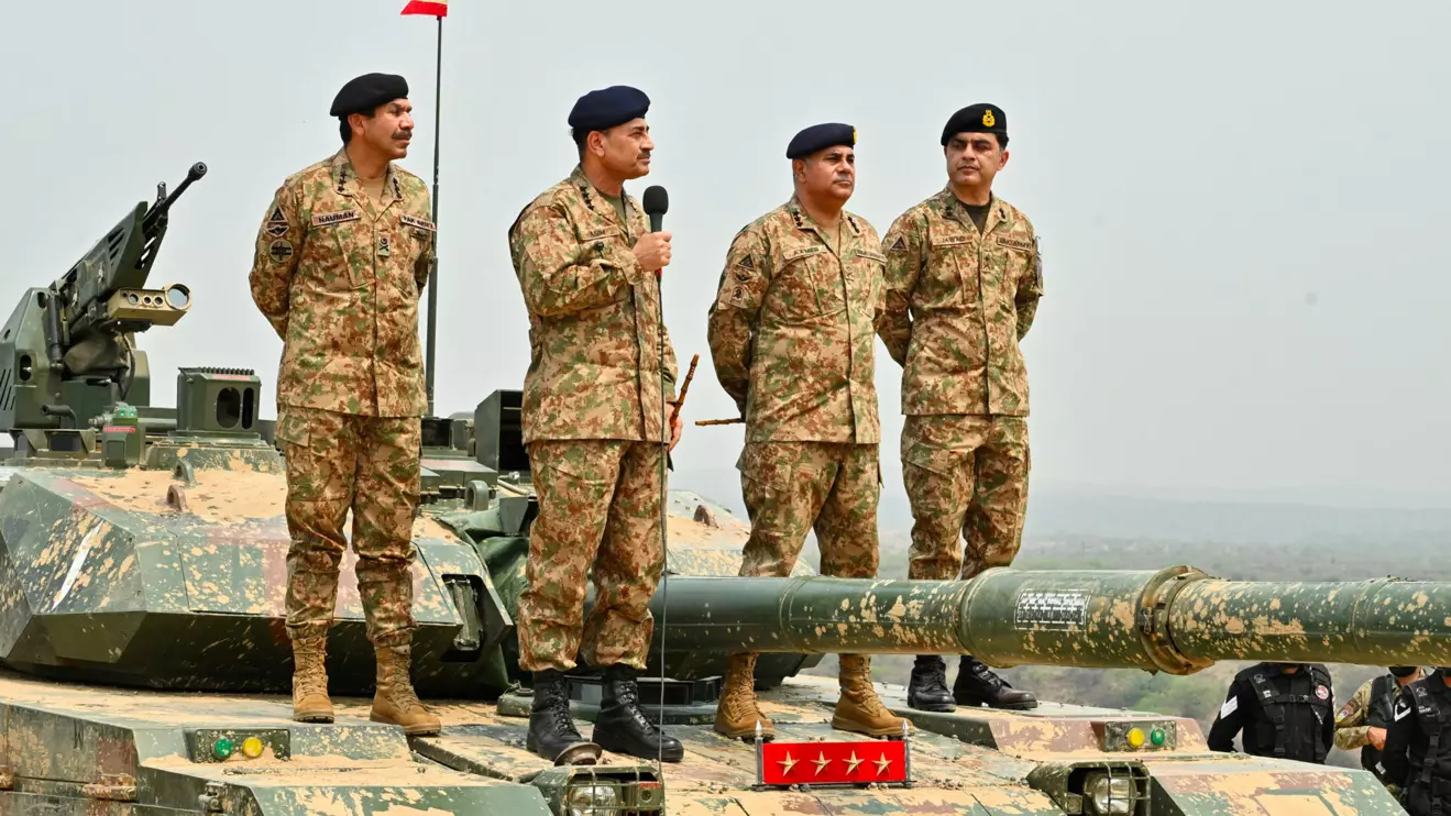 Chief of Army Staff of Pakistan Asim Munir holds a microphone during his visit at the Tilla Field Firing Ranges (TFFR) to witness the Exercise Hammer Strike, a high-intensity field training exercise conducted by the Pakistan Army's Mangla Strike Corps, in Mangla, Pakistan May 1, 2025. Inter-Services Public Relations (ISPR)
