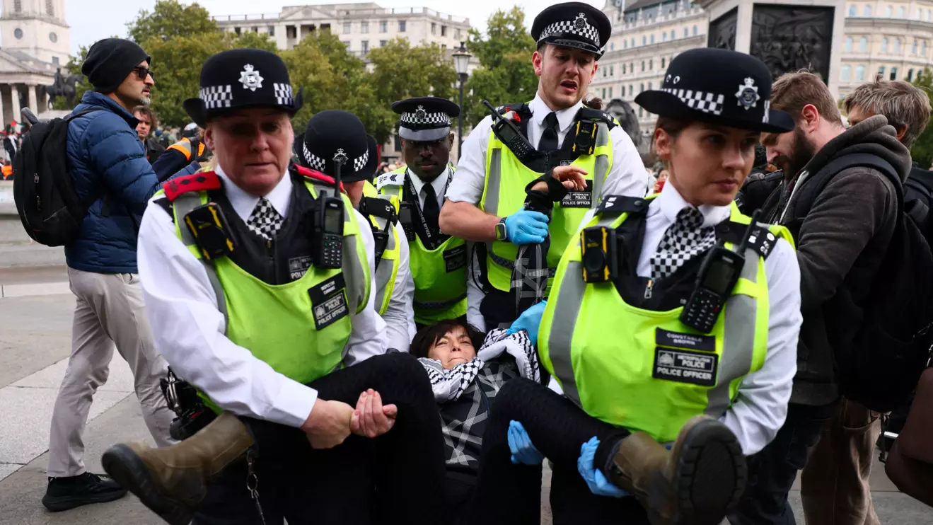 Police officers detain a protester during a mass demonstration organised by Defend our Juries, against the British government's ban on Palestine Action in London, Britain, October 4, 2025. Reuters/Jack Taylor