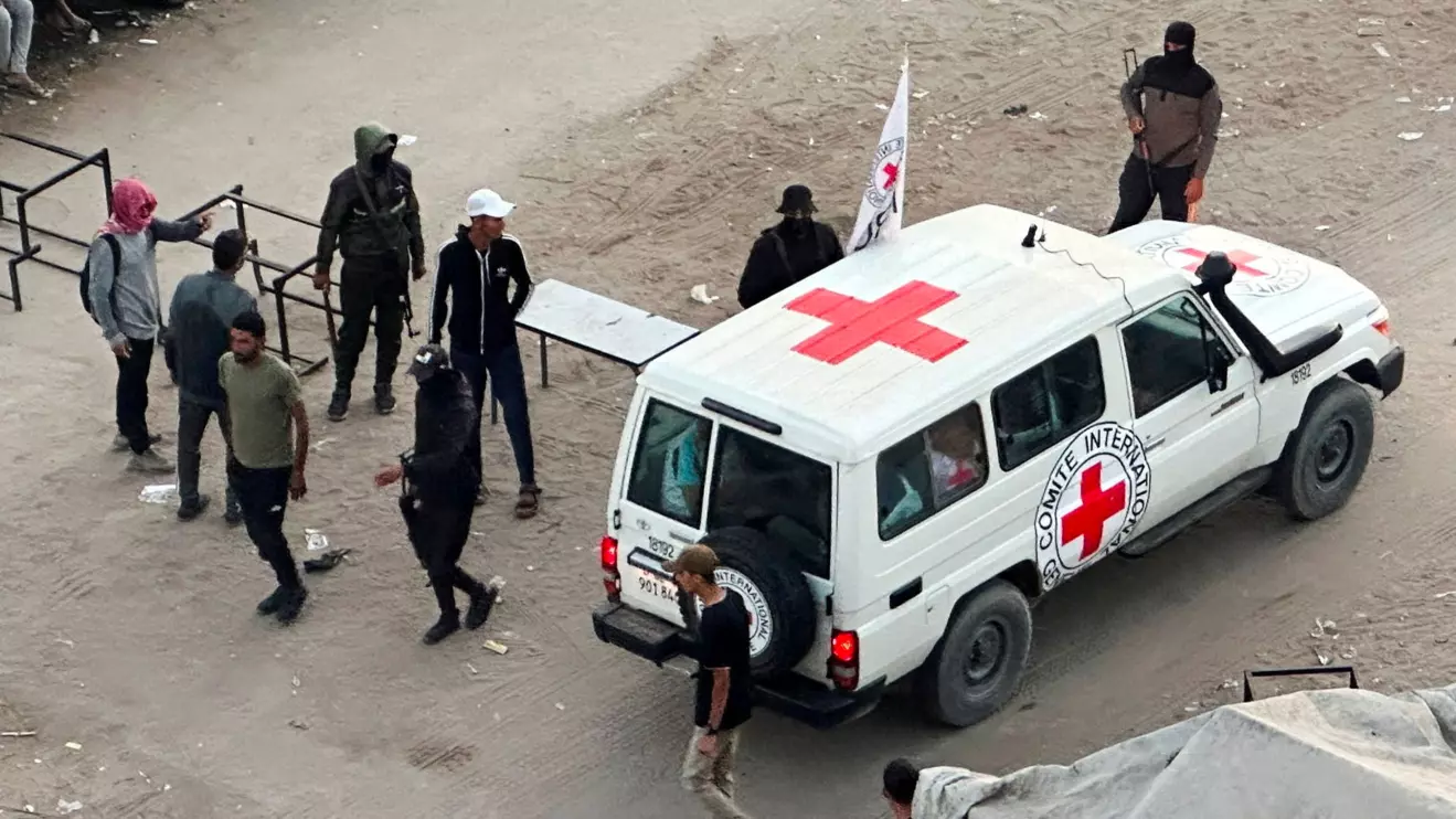 A Red Cross vehicle moves along a road before the expected release of hostages held in Gaza since the deadly October 7, 2023 attack, as part of a ceasefire and hostages-prisoners swap deal between Hamas and Israel, in Khan Younis, southern Gaza Strip, October 13, 2025. Reuters/Ramadan Abed