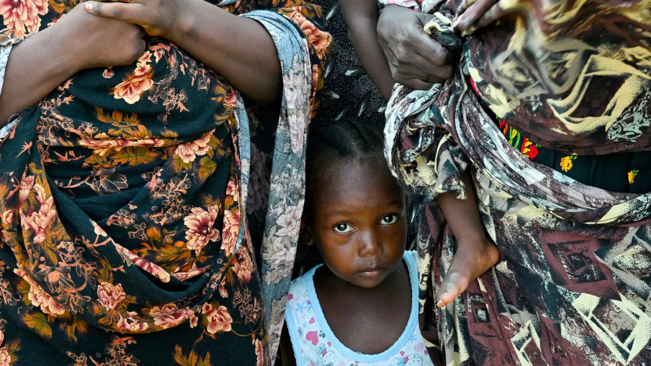 A child stands between two women at a school turned into a shelter, in Port Sudan, Sudan, August 29, 2024. ReutersAbrahim Mohammed Ishac