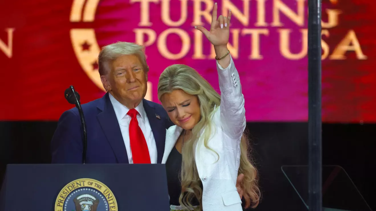 U.S. President Donald Trump embraces Erika Kirk as she gestures, during a memorial service for her husband, slain conservative commentator Charlie Kirk, at State Farm Stadium in Arizona, U.S., September 21, 2025. Reuters/Carlos Barria