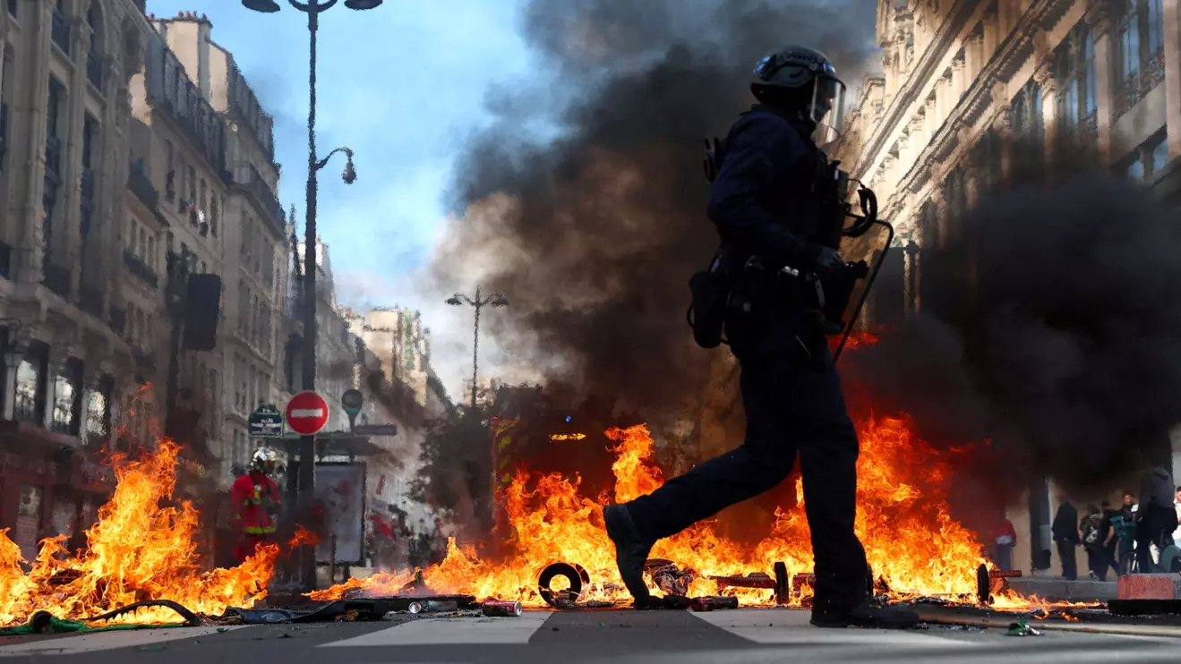 French riot police walk past burning objects in a street amid clashes with protesters in Paris as part of nationwide protests against the cost of living and rising fuel prices called by the "Yellow Vests" movement, joined by French high school and university students, teachers and parents demanding better school conditions and government action, as well as labour unions, workers, farmers and retirees, France, October 17, 2026. ReutersAbdul Saboor