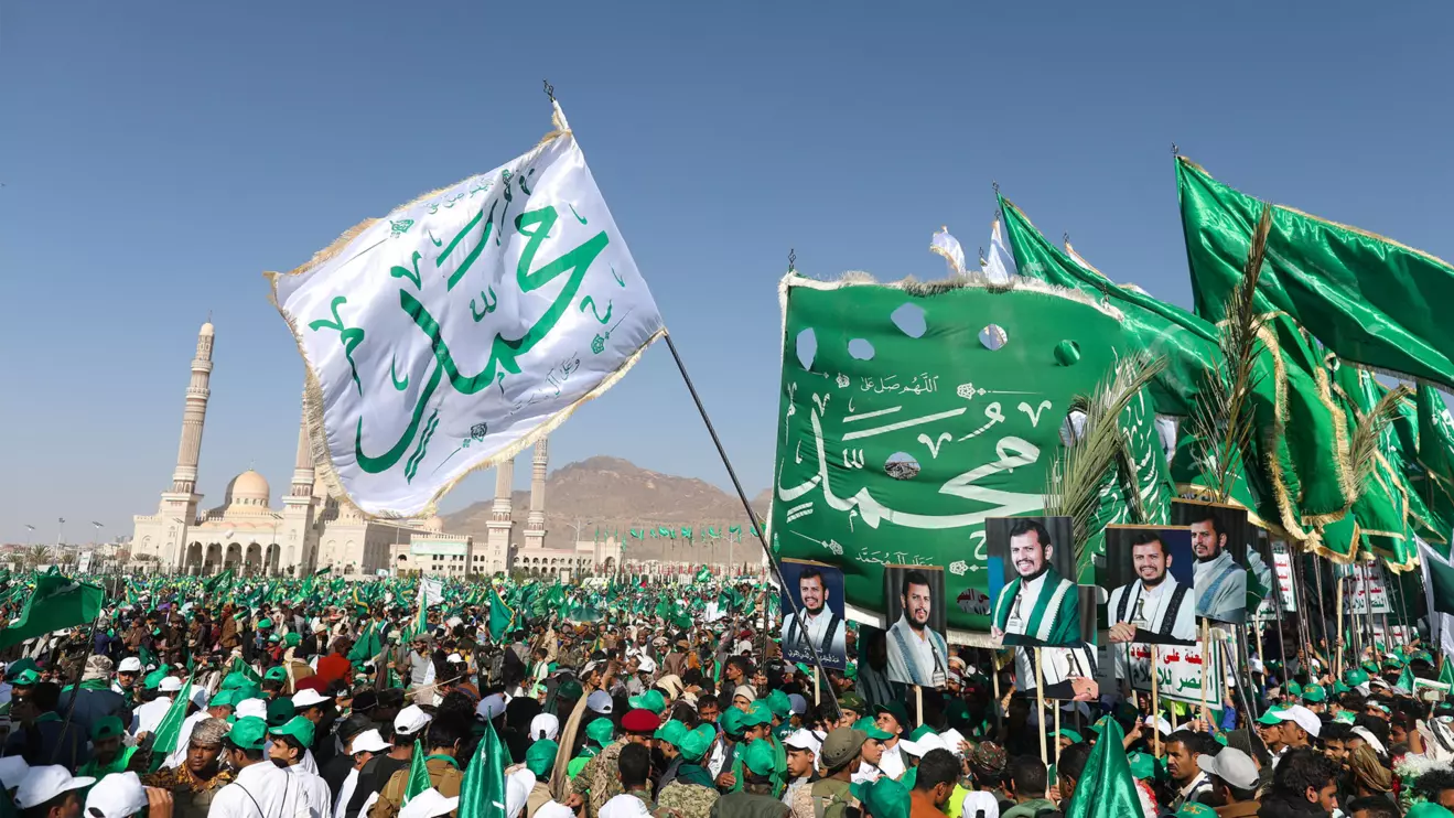 Houthi supporters hold up flags and posters of the Houthi leader Abdul-Malik Badruddin al-Houthi during a rally to mark the Prophet Muhammad's birthday in Sanaa, Reuters/Khaled Abdullah/File Photo