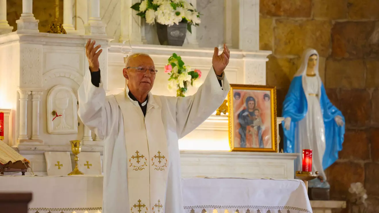 Reverend Najib Amil gestures during a mass at St. George Church in the Christian town of Rmeich, near the Israel-Lebanon border Reuters/Aziz Taher