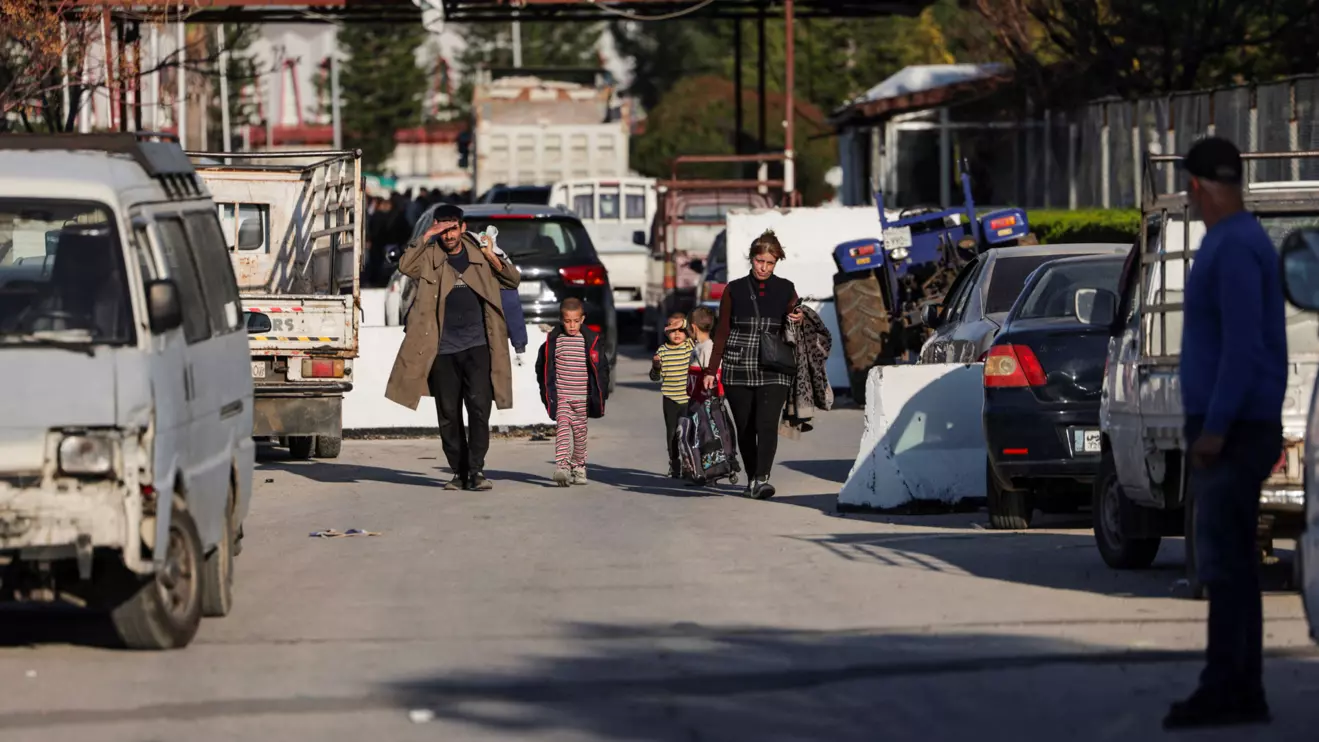 Syrian Alawite woman Rana Bousheh, 34, leaves the Hmeimim air base with her family, to return to her village, in Latakia, Syria March 13, 2025. Reuters/Khalil Ashawi