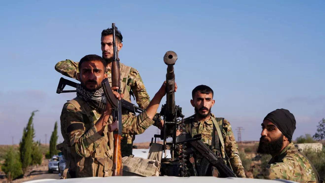 Members of Syrian security forces ride on a back of a truck in Druze city in Sweida, Syria July 15, 2025. Reuters/Karam al-Masri