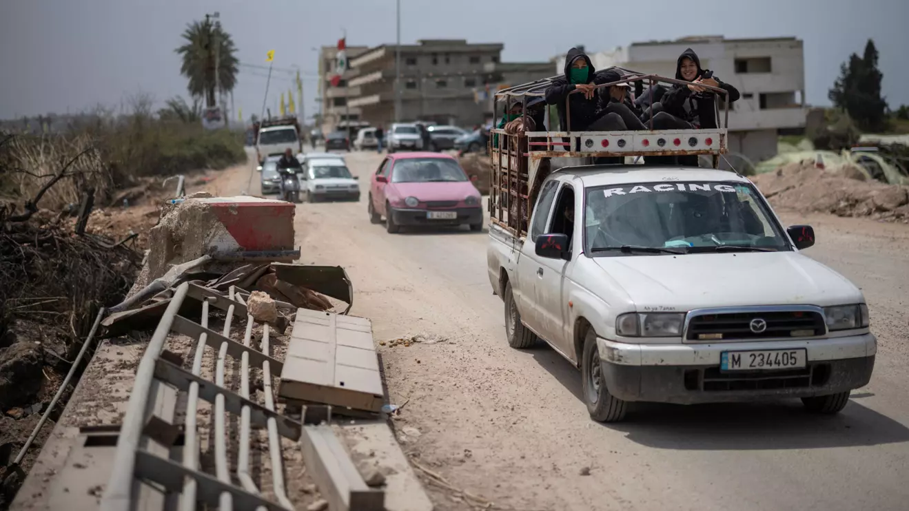 People travel in vehicles as displaced people make their way back to their home crossing the bridge linking southern Lebanon to the rest of the country, which was hit earlier in an Israeli strike, amid a 10-day ceasefire between Lebanon and Israel, in Qasmiyeh, Lebanon, April 19, 2026. Reuters/Marko Djurica