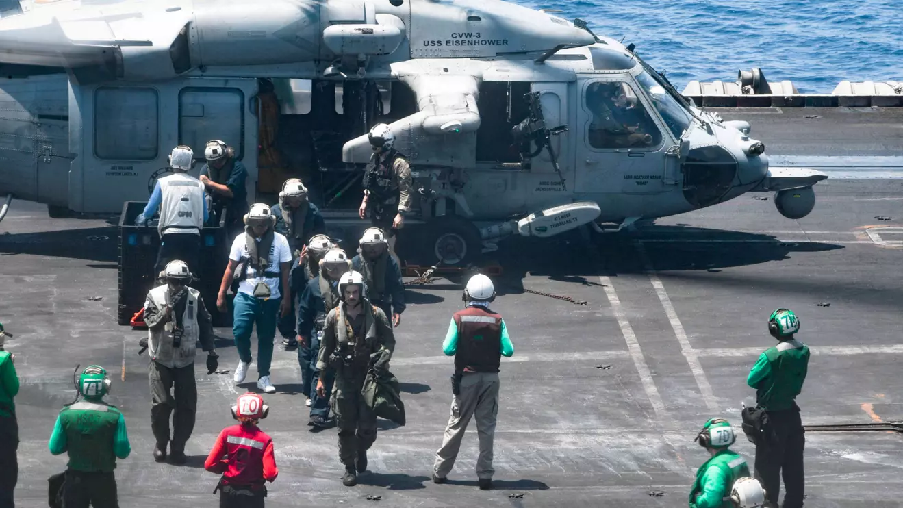Sailors from the Dwight D. Eisenhower Carrier Strike Group assist distressed mariners rescued from the Liberian-flagged, Greek-owned bulk carrier M/V Tutor that was attacked by Houthis, in the Red Sea, June 15, 2024. U.S. Naval Forces Central Command/U.S. 5th Fleet/Handout via Reuters