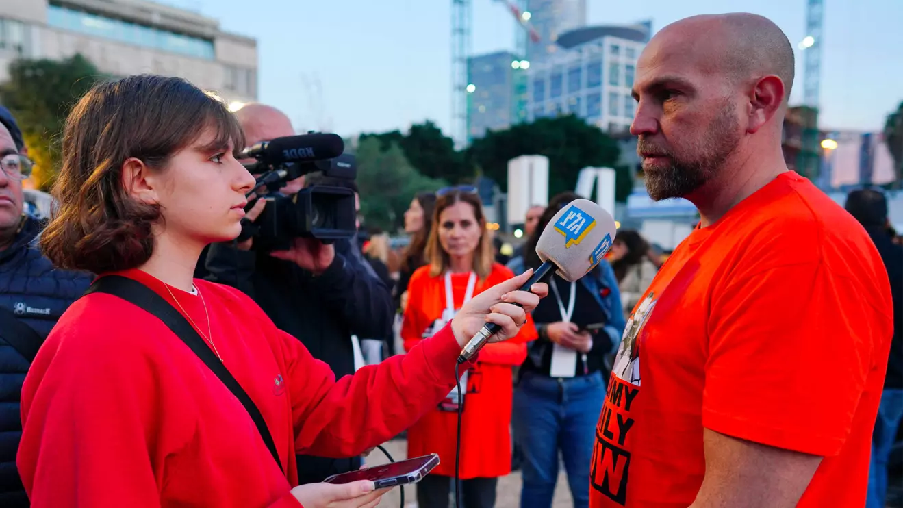 Shira Sheffi from Israel's Army Radio interviews Yosi Shnaider, a relative of Kfir Bibas, who was taken hostage along with his brother and parents on October 7, during an event to mark Kfir's first birthday as he is being held in captivity by Palestinian Islamist group Hamas in the Gaza Strip, in Tel Aviv, Israel, January 18, 2024. Reuters/Alexandre Meneghini