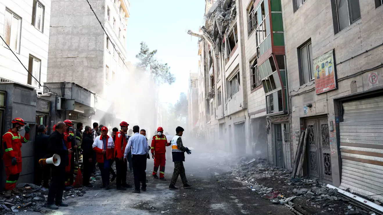 Emergency responders inspect the site of a residential building damaged by a strike, amid the U.S.-Israeli conflict with Iran, in Tehran, Iran, March 27, 2026. Majid Asgaripour/WANA (West Asia News Agency) via Reuters