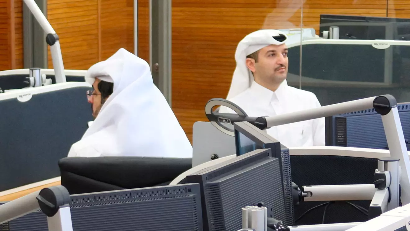 One of Qatar’s lead negotiators Abdullah Al Sulaiti (R) works inside an operation room set up to coordinate the truce and release of hostages between Israel and the Palestinian Islamist group Hamas, at the National Command Centre in Dohan © Reuters/Imad Creidi