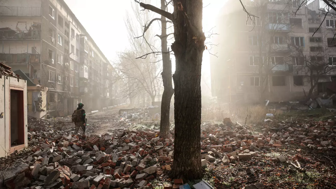 A Ukrainian serviceman walks near apartment buildings damaged by a Russian military strike, amid Russia's attack on Ukraine, in the frontline town of Kostiantynivka in Donetsk region, Ukraine November 15, 2025. Oleg Petrasiuk/Press Service of the 24th King Danylo Separate Mechanized Brigade of the Ukrainian Armed Forces
