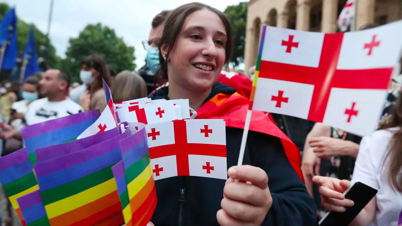 A participant distribute flags during a rally in support of those who were injured during the July 5 protests, when a pride march was disrupted by members of violent groups before it could begin, in Tbilisi, Georgia July 6, 2021. Reuters/Irakli Gedenidze