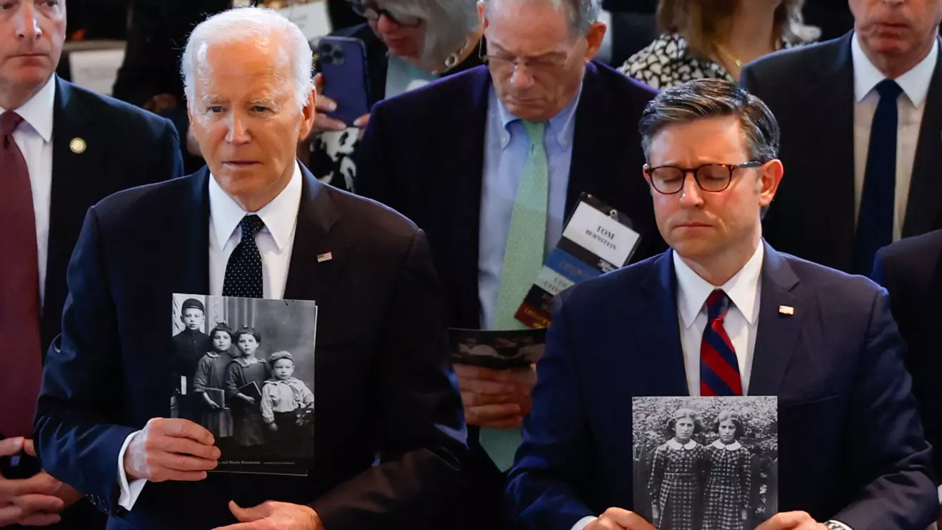 U.S. President Joe Biden and Speaker of the U.S. House of Representatives Mike Johnson (R-LA) hold photographs of the Holocaust victims on the day he addresses rising levels of antisemitism, at the U.S. Holocaust Memorial Museum's Annual Days of Remembrance ceremony, at the U.S. Capitol building in Washington, May 7, 2024. Reuters/Evelyn Hockstein