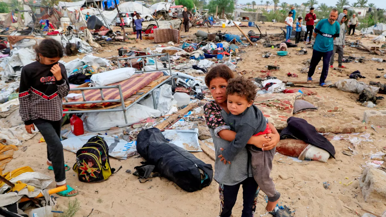 Palestinians inspect the damage at the site of an Israeli strike on a tent camp sheltering displaced people, in Khan Younis, southern Gaza Strip, May 18, 2025. Reuters/Hatem Khaled
