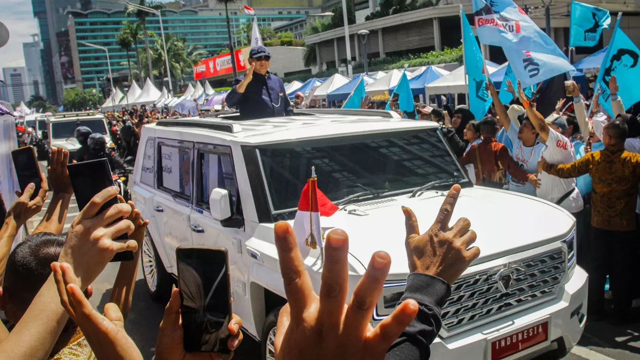 Indonesia's new President Prabowo Subianto greets people as he rides in a car after his presidential inauguration in Jakarta, Indonesia, October 20, 2024, in this photo taken by Antara Foto. Antara Foto/Zaky Fahreziansyah/via Reuters