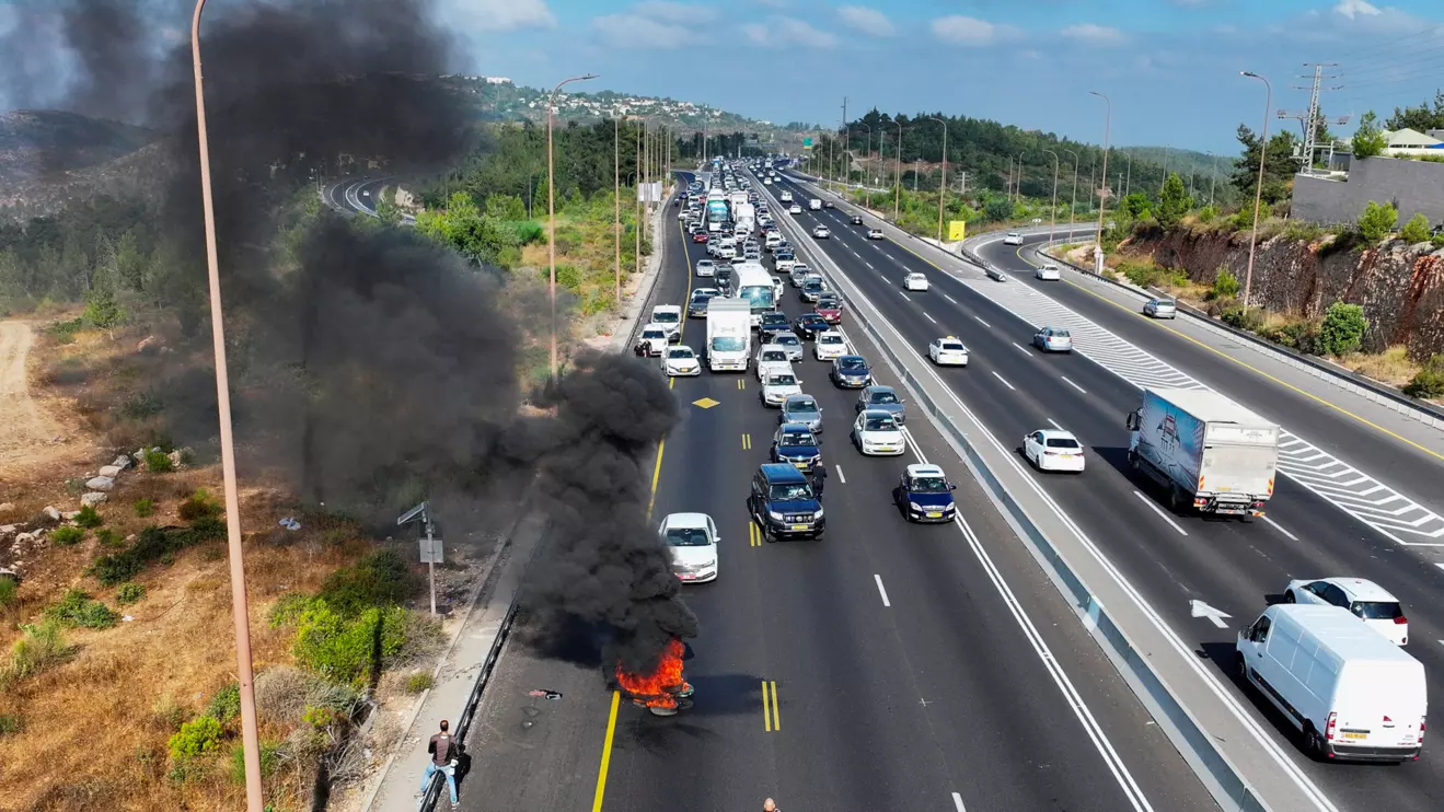 A drone view shows a fire that was lit by anti-government protesters on a day of protests marking 9 months since the deadly October 7 attack, under the slogan "Israel comes to a standstill", near Shoresh, Israel, July 7, 2024. Reuters/Ilan Rosenberg