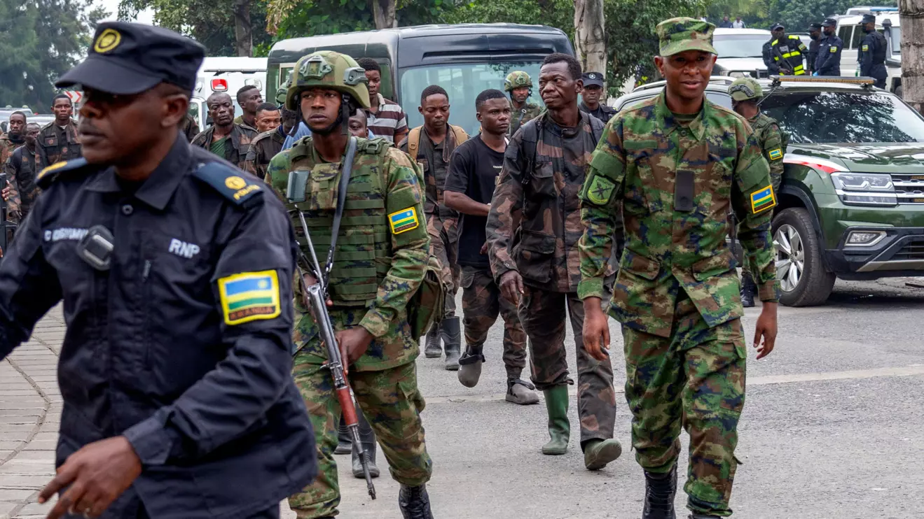 Rwandan security officers escort members of the Armed Forces of the Democratic Republic of the Congo (FARDC), who surrendered in Goma, eastern Democratic Republic of Congo, following fighting between M23 rebels and the FARDC, in Gisenyi, Rwanda, January 27, 2025. Reuters/Jean Bizimana