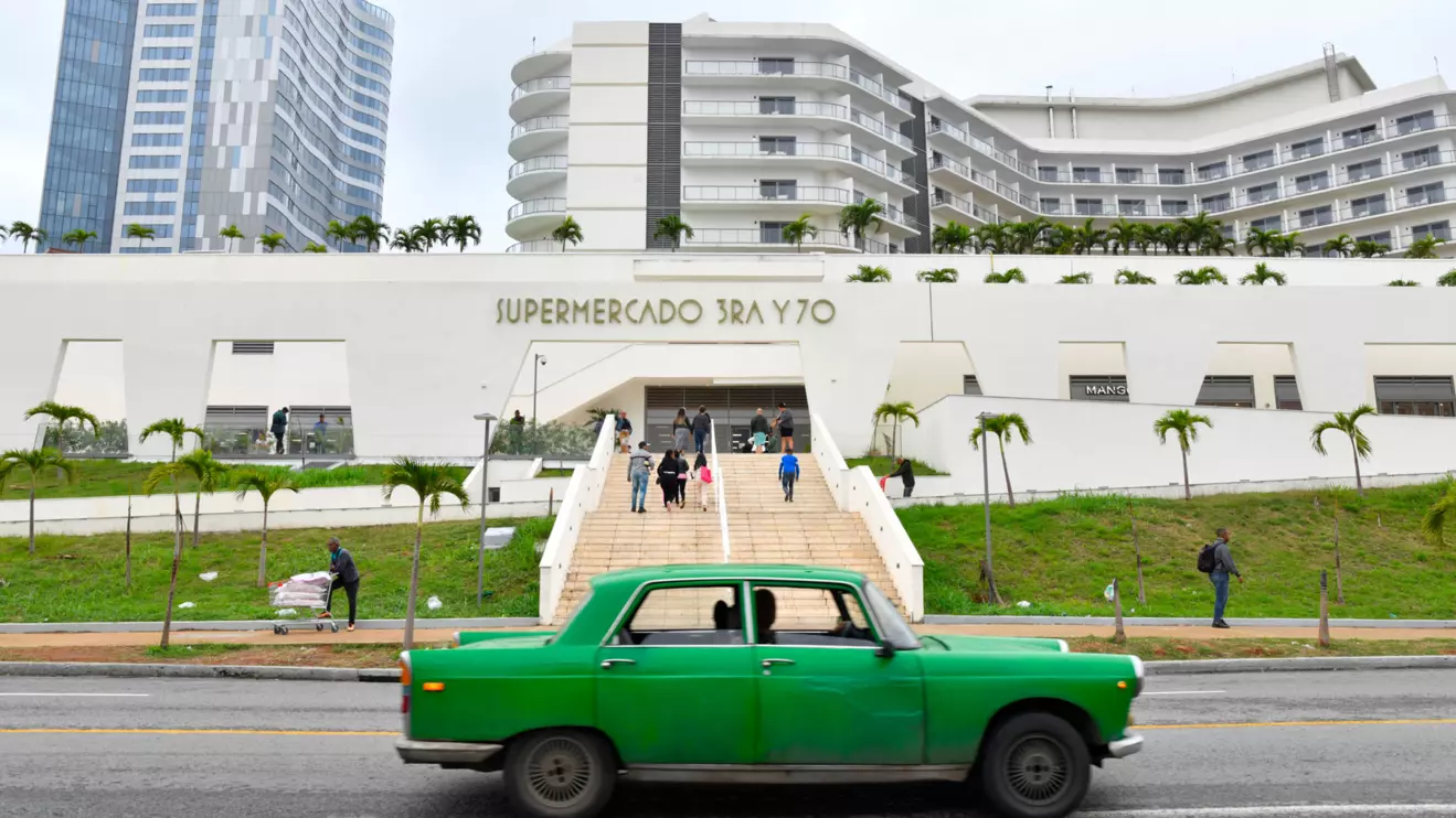 A vintage car drives past a recently opened grocery store, the first to accept hard U.S. currency on the island in nearly two decades, in Havana, Cuba, January 23, 2025. Reuters/Norlys Perez