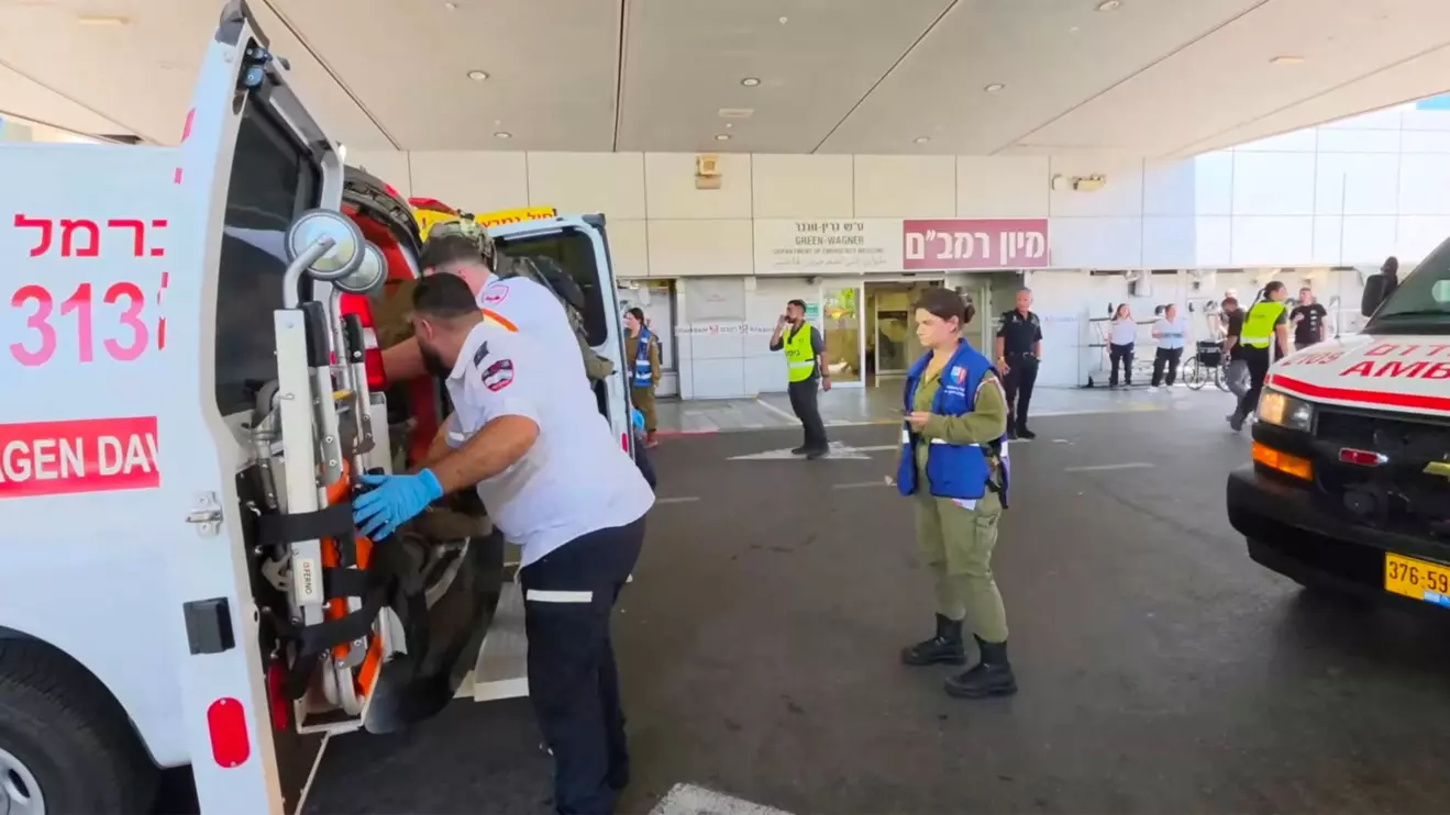 Paramedics work to move an Israeli casualty from inside an ambulance, after being wounded in an explosion in Lebanon, at Rambam Health Care Campus in Haifa, Israel, August 5, 2026. Rambam Health Care Campus/Handout via Reuters
