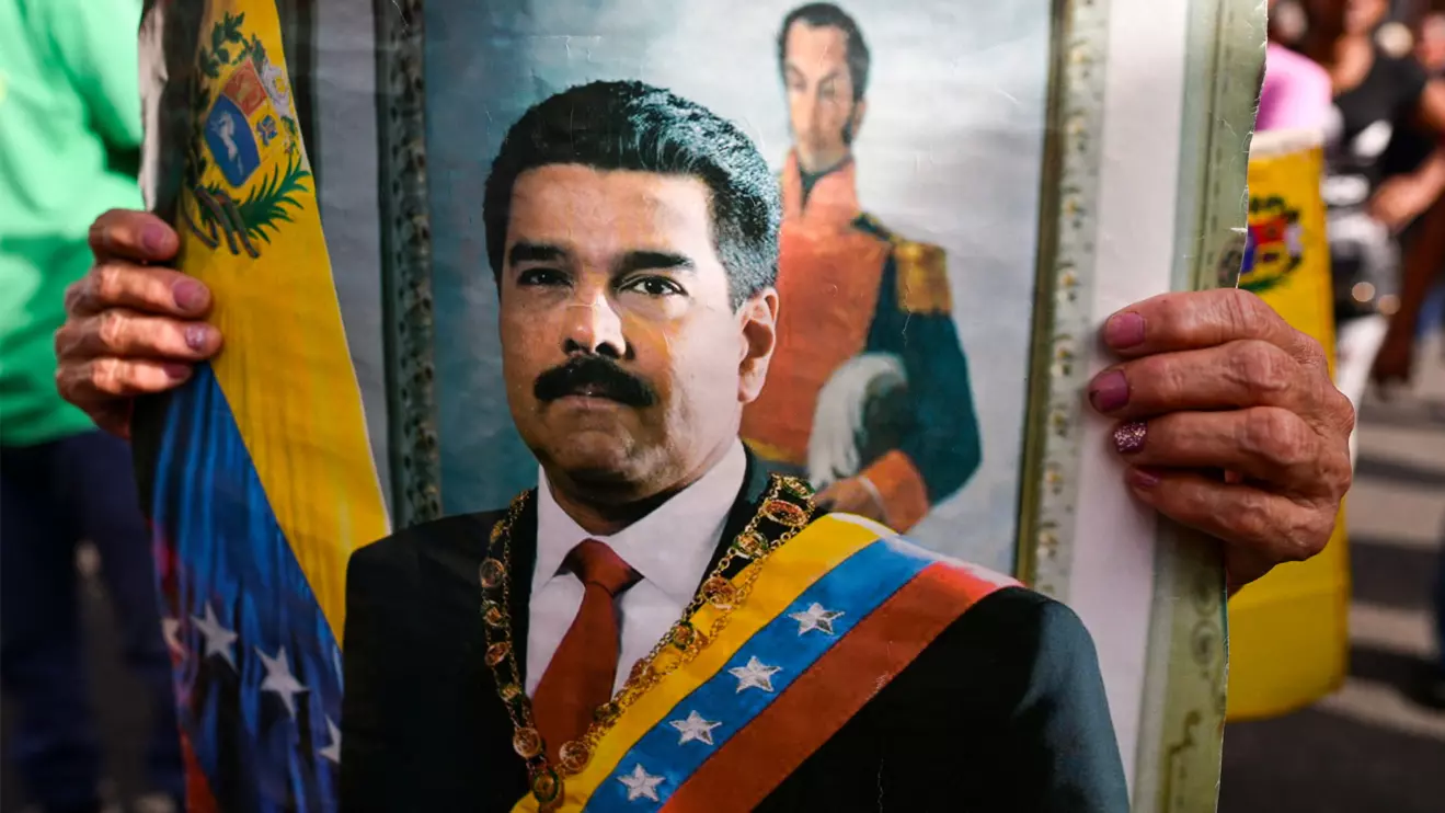 A person holds an image of Venezuelan President Nicolas Maduro as government supporters gather following a U.S. strike on Venezuela where President Nicolas Maduro and his wife, Cilia Flores, were captured, in Santiago, Chile January 3, 2026. Reuters/ Gaby Or