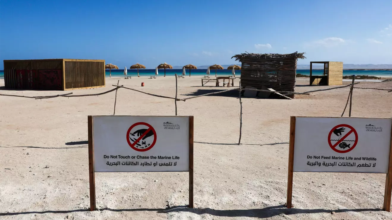 View of signs surrounded with a barrier made of wooden sticks in front of Ras Hankorab beach in Wadi el-Gemal National Park, home to one of the country's last unspoiled marine ecosystems with crystal clear waters and white sands, at southern Egypt's Red Sea coast in Marsa Alam, Reuters