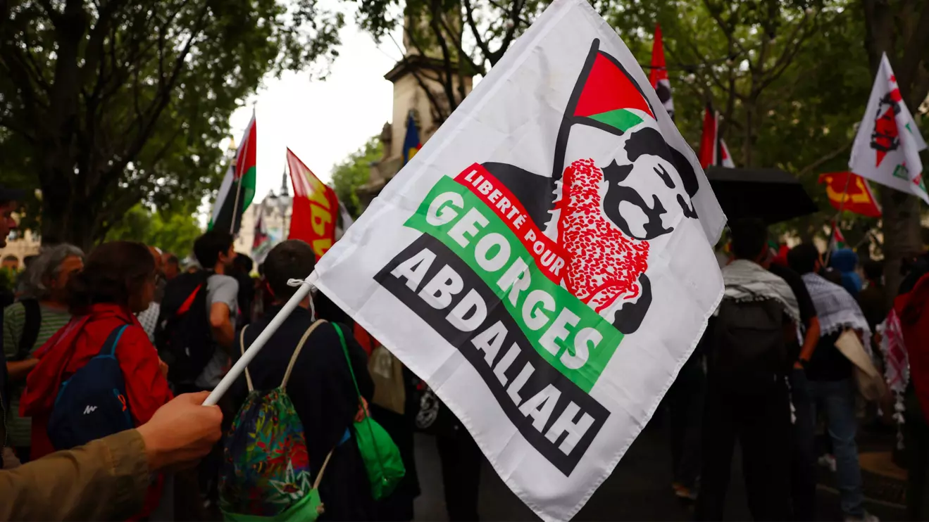A protester holds a flag with the slogan "Freedom for Georges Abdallah" during a demonstration to demand the immediate and unconditional release of Georges Ibrahim Abdallah, a Lebanese militant held in France since 1984, on the eve of a French appeals court ruling on his conditional release, in Paris, France, July 16, 2025. Reuters/Abdul Saboor