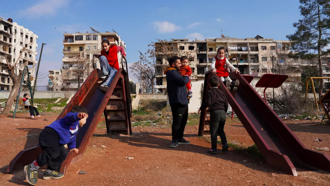 Syrian Ahmed Al-Sheikh, who returned to his homeland from neighbouring Turkey after the fall of Bashar al-Assad, plays with his children at a park in Aleppo, Syria January 25, 2025. Reuters/Karam al-Masri