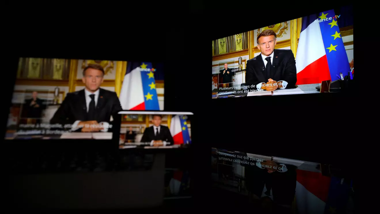 French President Emmanuel Macron appears on screen as he makes a television address to the nation a day after clashes during a national day of demonstrations against the cost of living and rising fuel prices, near Marseille, France, October 18, 2026. Reuters/Manon Cruz