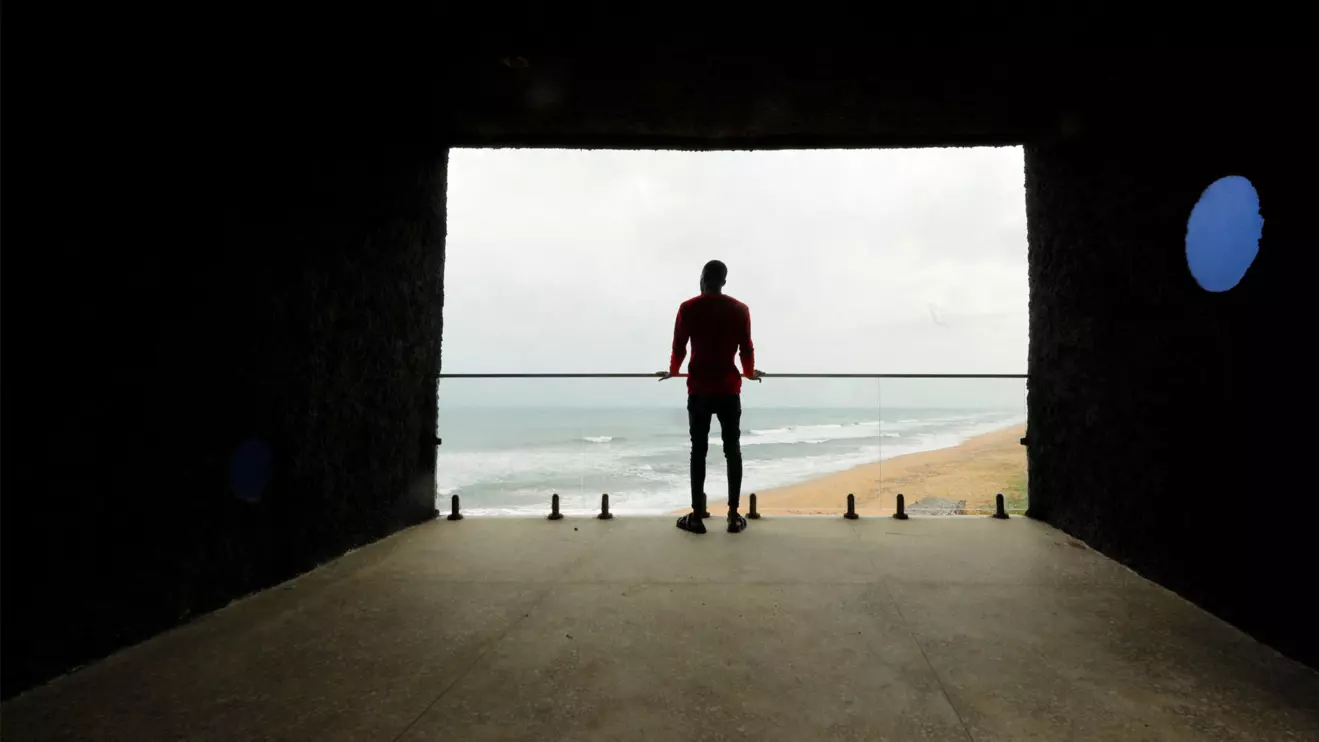 A man looks out from a sea viewing commenorative building that is known locally as 'The Tunnel' that is sited near the 'Point of No Return' where slaves were shipped from the slave port at Badagry, Nigeria, Reuters 