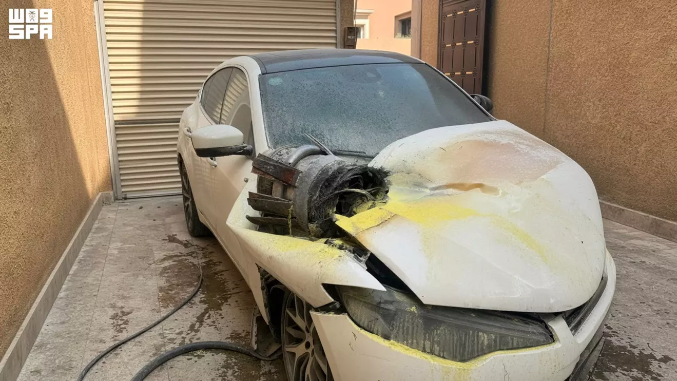 A vehicle damaged by debris that authorities said fell from the interception of a ballistic missile, is pictured at a residential property in Riyadh, Saudi Arabia, October 14, 2026. Saudi Press Agency