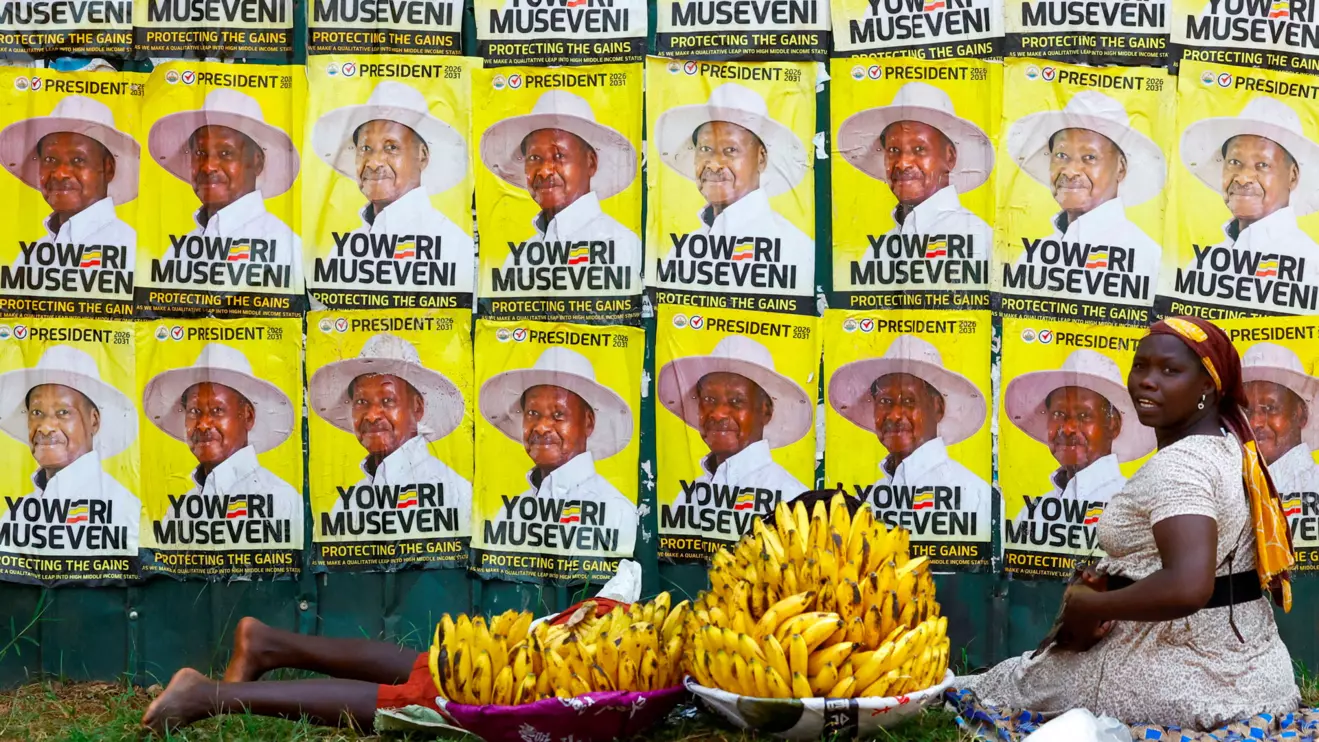 Women sell bananas near campaign posters of Uganda's President and the leader of ruling National Resistance Movement (NRM) party, Yoweri Museveni, following the general elections in Kampala, Uganda January 17, 2026. Reuters/Thomas Mukoya