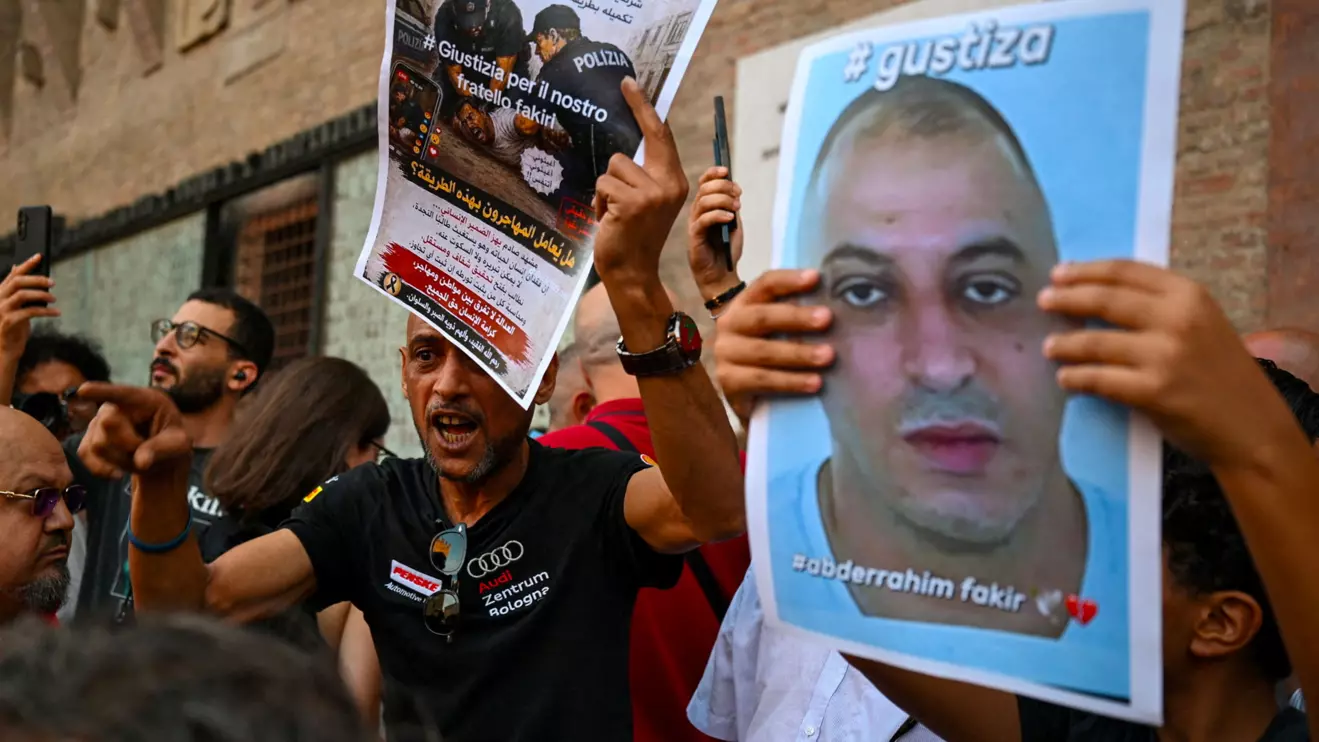 A protester gestures while holding a flyer during a protest following the death of Abderrahim Fakir in Bologna, Italy, July 20, 2026. Reuters/Michele Lapini