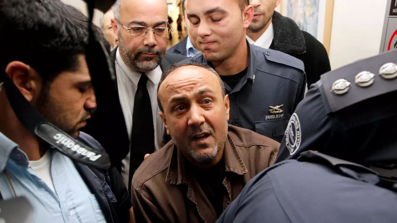 Jailed Fatah leader Marwan Barghouti (C) is accompanied by Israeli prison guards after a deliberation at Jerusalem Magistrate's court January 25, 2012. Convicted of murder for his role in attacks on Israelis, Barghouti was jailed for life by Israel in 2004. Reuters/Ammar Awad