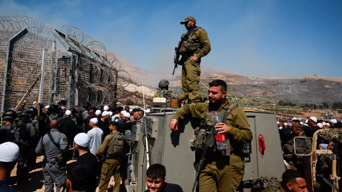 Members of Israeli security forces stand at the ceasefire line between the Israeli-occupied Golan Heights and Syria, July 16, 2025. Reuters/Ammar Awad