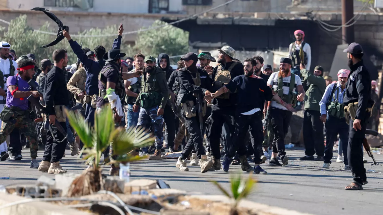 Internal Security Forces officers escort a Druze prisoner and prevent him from being attacked by Bedouins, at an Internal Security Forces checkpoint working to prevent Bedouin fighters from advancing towards Sweida, following renewed fighting between Bedouin fighters and Druze gunmen, despite an announced truce, in Walgha, Sweida province, Syria July 19, 2025. Reuters/Khalil Ashawi